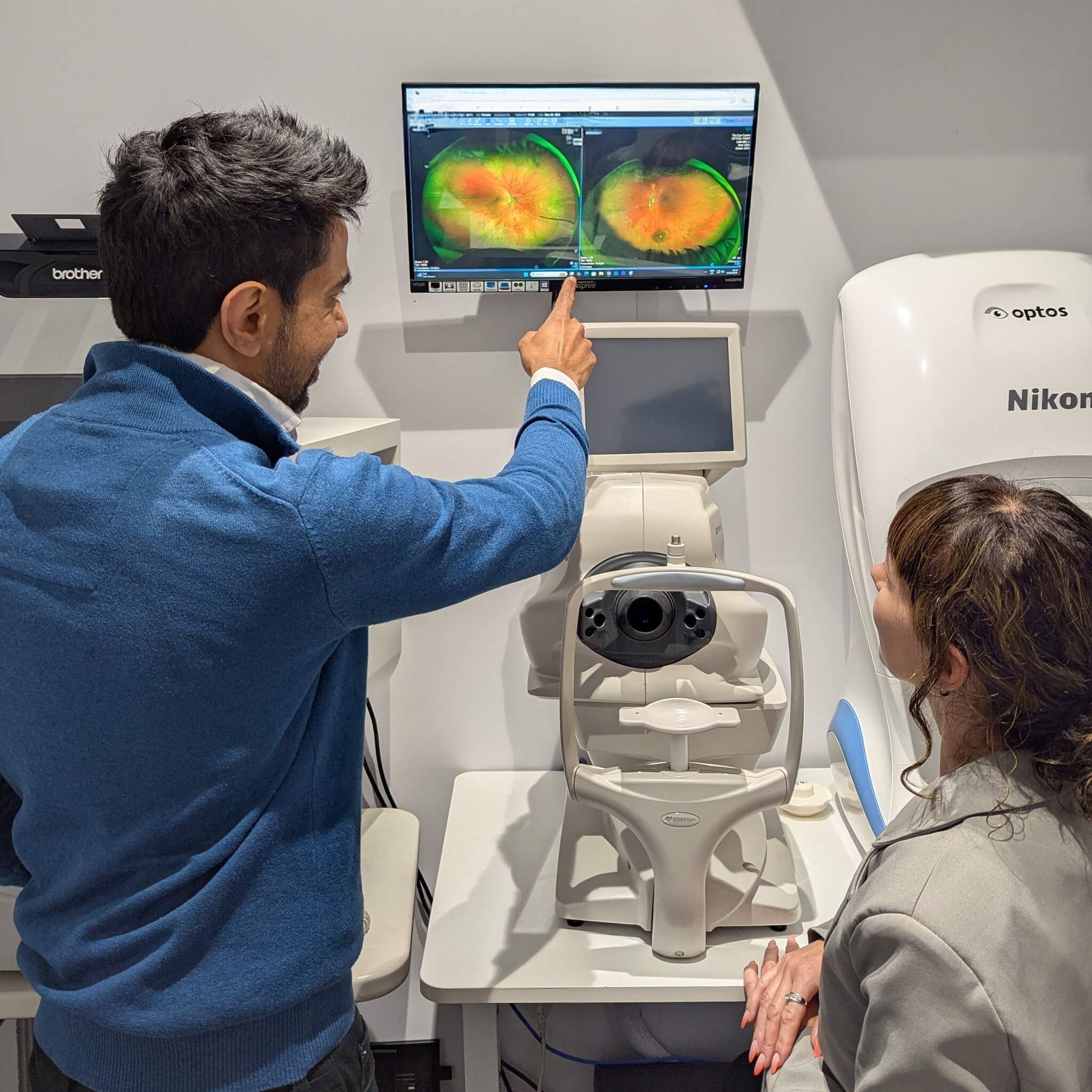 Paras Kothari reviewing an Optomap scan with a patient at The Eye Centre in South London